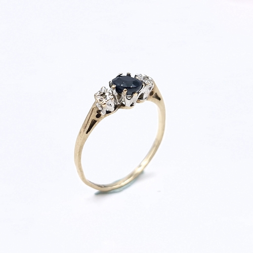 1373 - Star Lot: A very beautiful blue sapphire with two diamonds set in nine carat gold ring. Ring Size: M... 