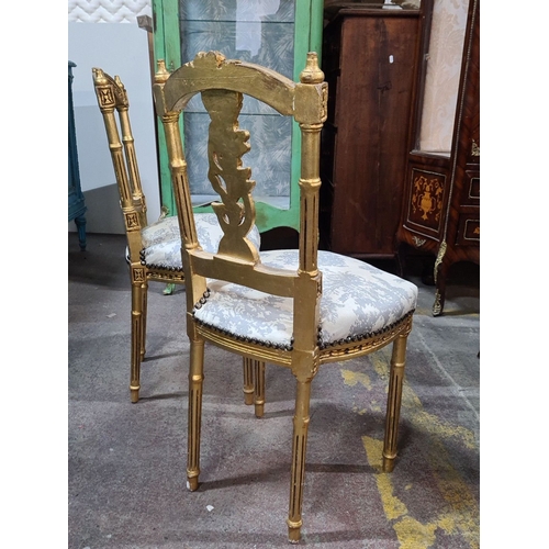 1383 - Star lot : Pair of Neoclassical-style giltwood chairs with intricately carved backs and upholstered ... 