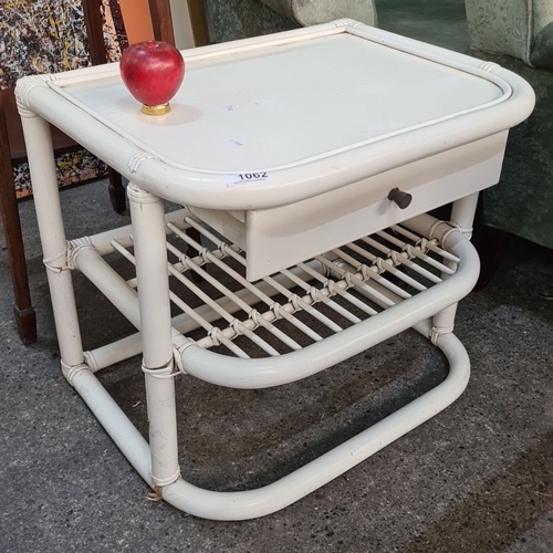 1394 - A White rattan side table with a single drawer and open shelf, featuring a curved rectangular design... 