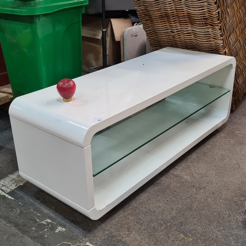 1191 - Star Lot : A lovely designer style curved white coffee table with glass storage shelf. In very good ... 