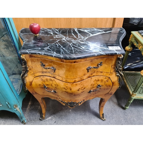 1217 - A French Style bombe chest with a cold Italian  black marble top, Curved legs and metal hardware. Ha... 