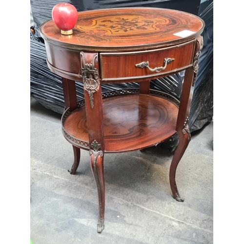 1226 - A Louis XV Style table with a pull out drawer. An additional shelf beneath featuring a pierced galle... 