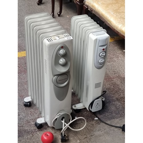 833 - Pair of Winterwarm oil-filled radiators. Portable design with caster wheels.