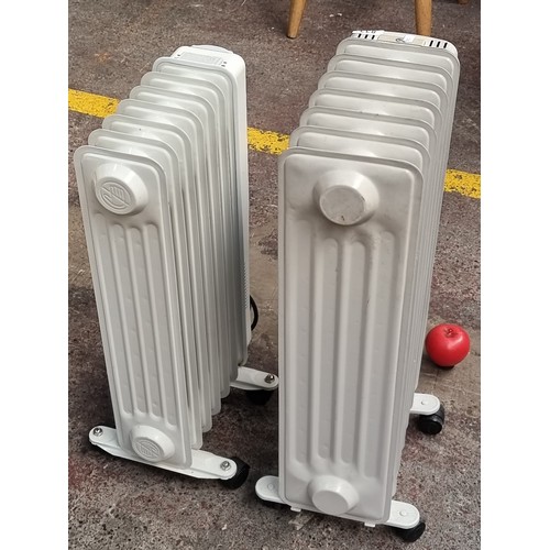 833 - Pair of Winterwarm oil-filled radiators. Portable design with caster wheels.