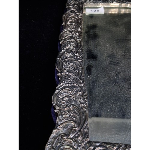 128 - A fabulous very large dressing table bevelled mirror of rectangular form, housed in an elaborate fra... 