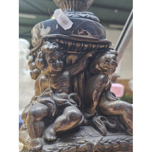 385 - Star Lot : A heavy large  antique French brass and marble table lamp. Features four cherubs to base.... 