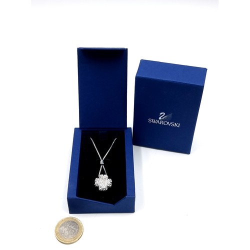 114 - A Swarovski Crystal flower pendant necklace. Housed in original box and packaging. Comes with certif... 