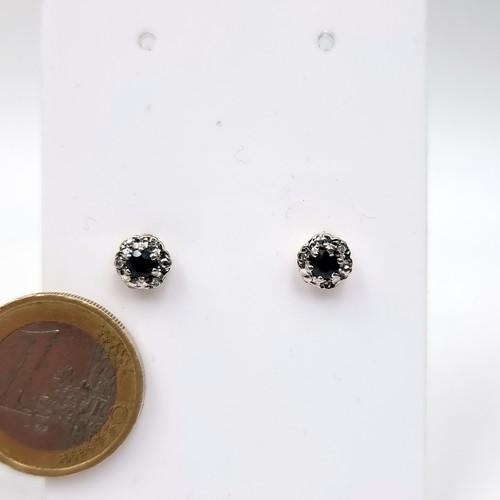 60 - A pair of sapphire and diamond stud earrings set in nine carat gold. Total weight - 1.13 grams.