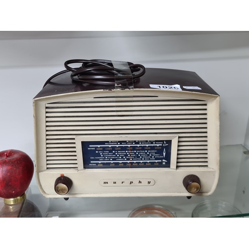 1026 - A handsome 'Murphy Radio'. Model:265142. Features a classic cream and brown Bakelite casing with dua... 