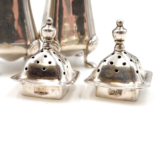 2 - Two silver pepperettes with attractive domed finial tops each set in four paw feet hallmarked Birmin... 