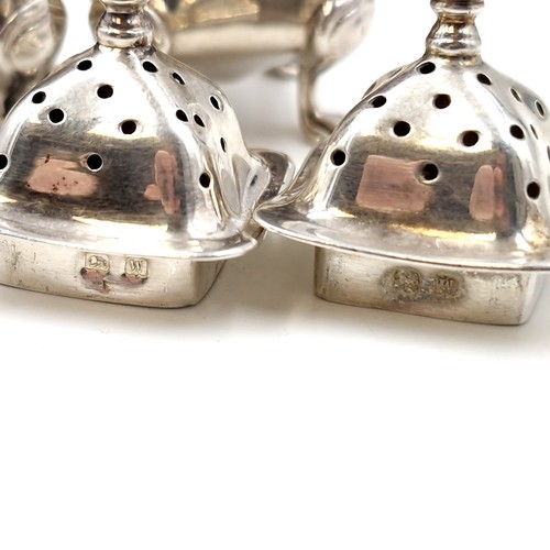 2 - Two silver pepperettes with attractive domed finial tops each set in four paw feet hallmarked Birmin... 