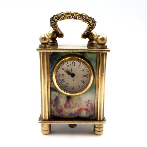 9 - Star Lot : An antique miniature vintage brass carriage clock with handle with three panels depicting... 