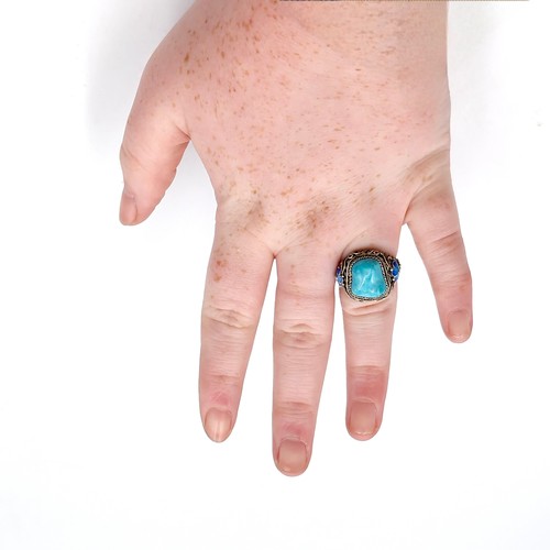 41 - A very pretty vintage style turquoise stone ring with enamel floral detailing mount with adjustable ... 