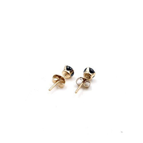 48 - A nine carat gold sapphire pair of stud earrings. Weight - 0.4 grams.