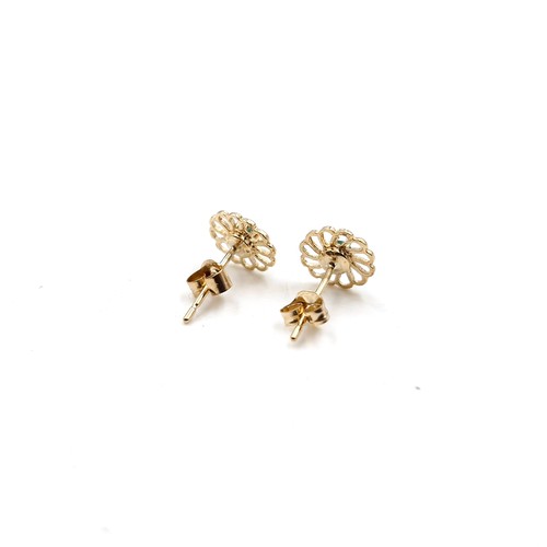 52 - A pair of nine carat gold emerald star burst stud earrings. Weight 0.62 grams.