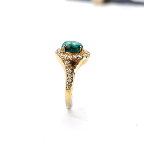 548 - A nine carat gold plated malachite cabochon stone ring with gem set mount and surround. Size - W. We... 