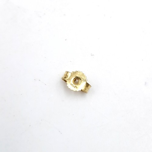 574 - Star Lot : A pair of 18 carat gold diamond and onyx stud earrings - marks stamped to post. Weight - ... 