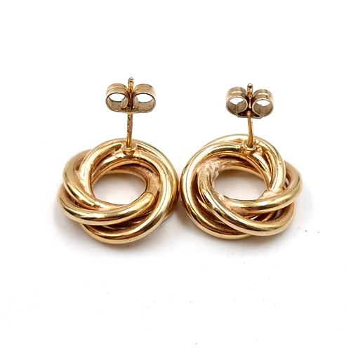 576 - A pair of nine carat gold circular twist stud earrings. Weight - 3.72 grams.