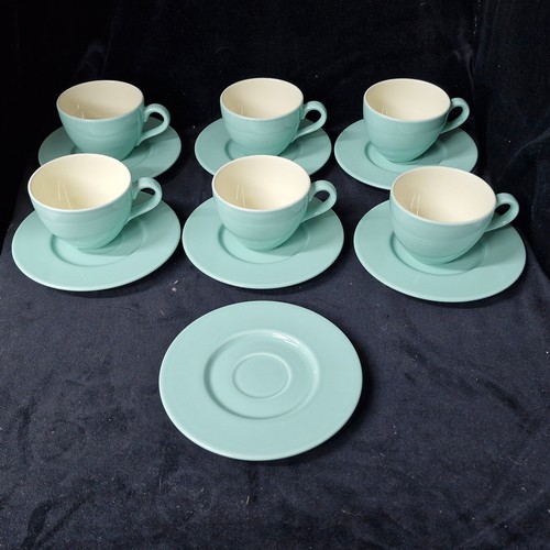 1020 - A box of new old stock containing ceramic cups and saucers. Includes six cups and seven saucers. Wit... 