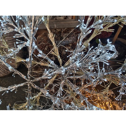 876 - Silver and gold decorative snowflake, metallic wire construction, featuring integrated lights.