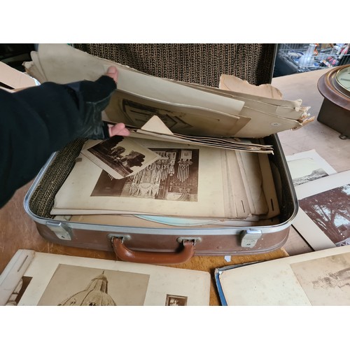 886 - Collection of vintage art prints and photographs in a suitcase, featuring classical and landscape sc... 