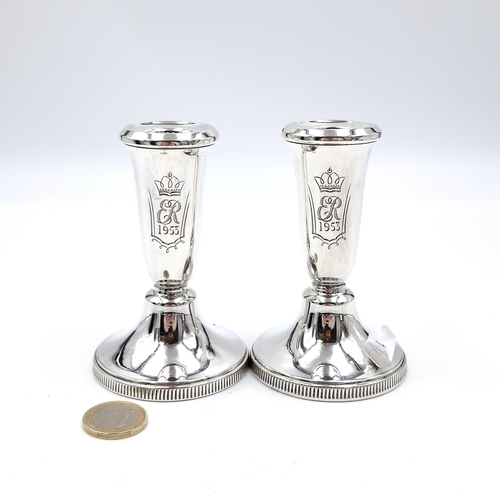 12 - A pair of sterling silver filled candle sticks hallmarked Birmingham with inscription ER 1953 (Coron... 