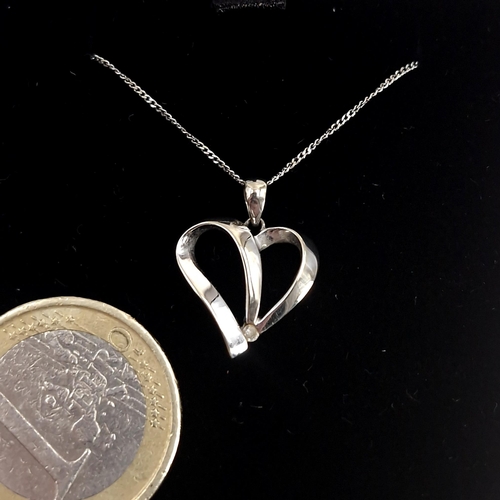 33 - A sterling silver heart pendant with diamond accent together with chain. Length of chain - 48 cms. B... 