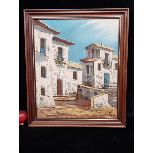 70 - A bright original oil on canvas painting. Features a Spanish Village. Rendered in blues, browns and ... 