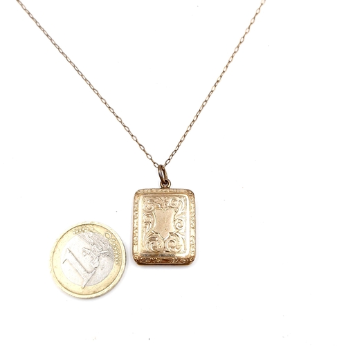 526 - Star Lot : A nine carat gold hinged locket & chain with foliette detailing. Length of chain - 46 cms... 