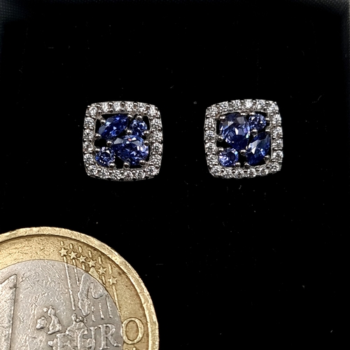 553 - A pair of Tanzanite sterling silver stud earrings set with white sapphire surround. Old new stock - ... 