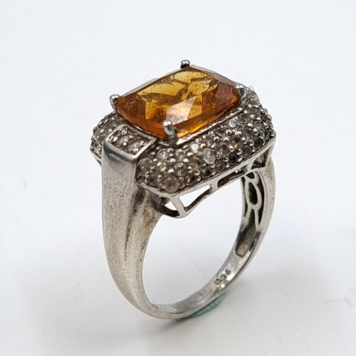 555 - A good vintage orange topaz stone ring with diamond surround mount set in sterling silver. Size - O.... 