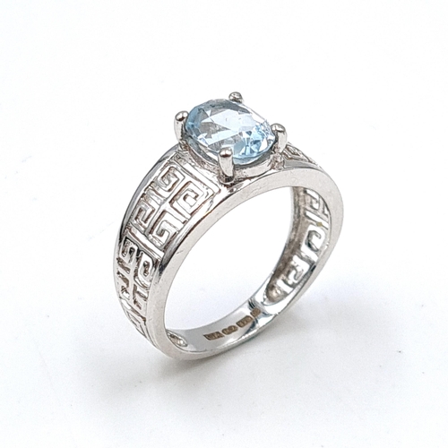 580 - Star Lot : A nine carat white gold topaz stone ring. Weight - 3 grams. Size - L 1/2. Boxed.