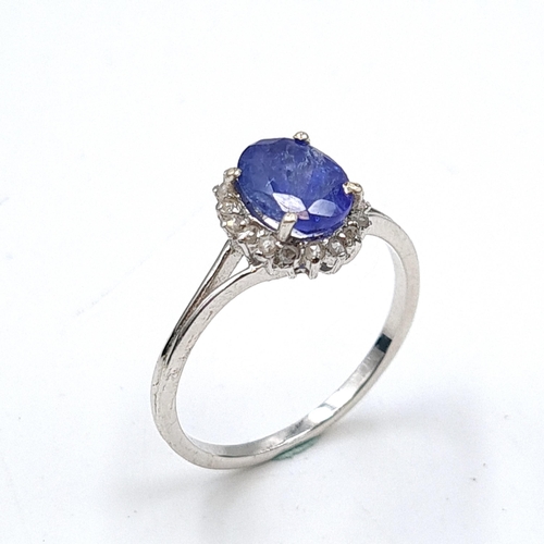 581 - Star Lot : A sapphire stone ring set with diamond surround set in sterling silver. Size - O. Weight ... 