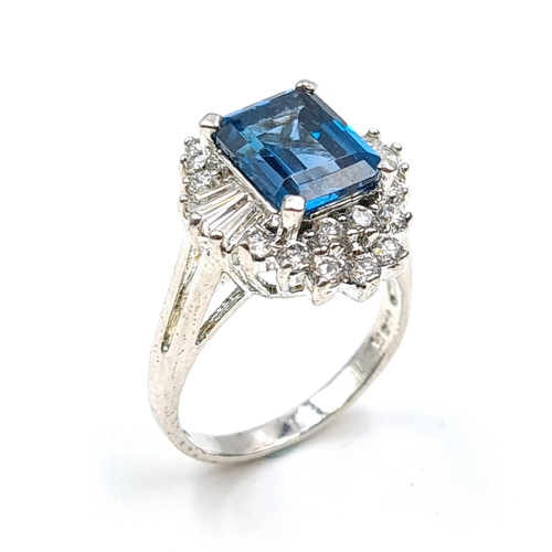 584 - A large blue topaz stone ring set in sterling silver. Size - N. Weight - 6.55 grams. Boxed.