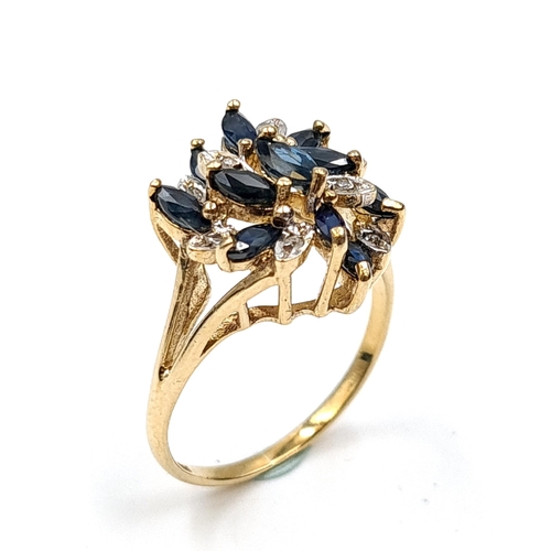 585 - Star Lot : An unusual large nine carat gold vintage sapphire & diamond ring. Size - N. Weight - 3.15... 