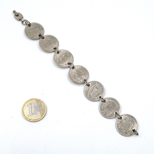 594 - An Irish silver seven coin bracelet. Weight - 22 grams.