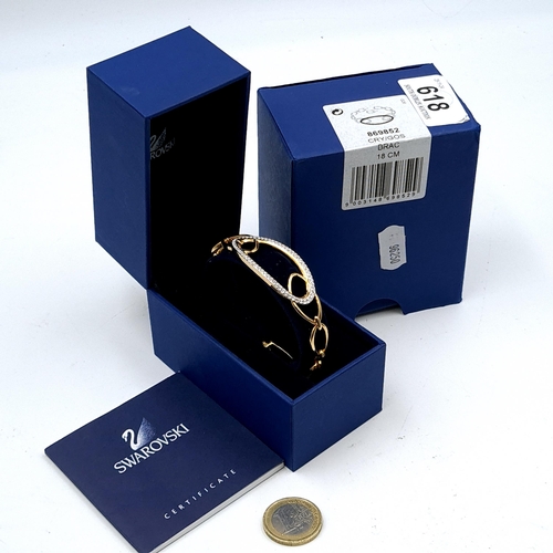 618 - A brand new Swarovski gold toned link bracelet with gem set mount. Comes with certificate in origina... 