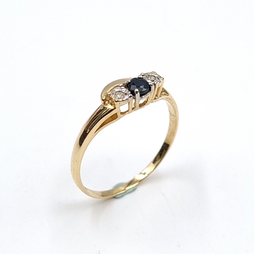 632 - Star Lot: A wonderful example of a nine carat gold sapphire ring with diamond shoulders. Stamped 375... 