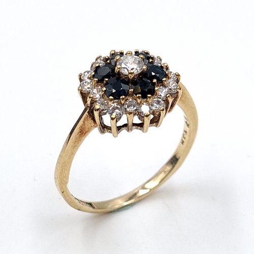 636 - Star Lot: An impressive sapphire and gem set cluster ring set in nine carat gold. Stamped 375. Ring ... 