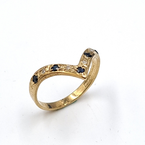 640 - Star Lot: A pretty vintage sapphire and diamond wishbone ring set in nine carat gold. Stamped 375. R... 