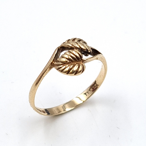 641 - Star Lot: A nice example of a nine carat gold ring with twin leaf motif. Stamped 375. Ring size Q. T... 