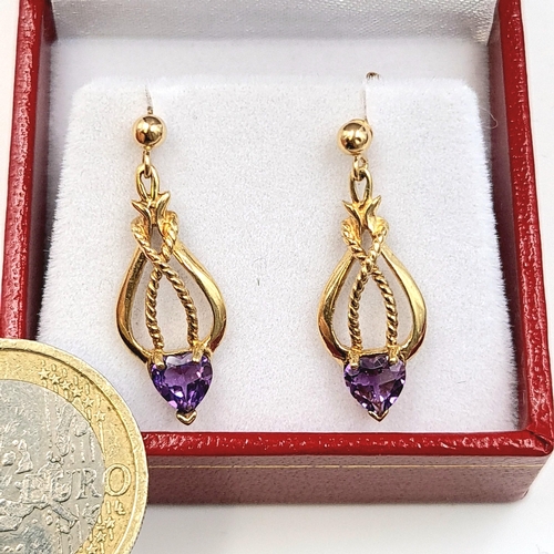 648 - Star Lot: A beautiful pair of nine carat gold Art Nouveau style drop earrings set with amethyst gems... 