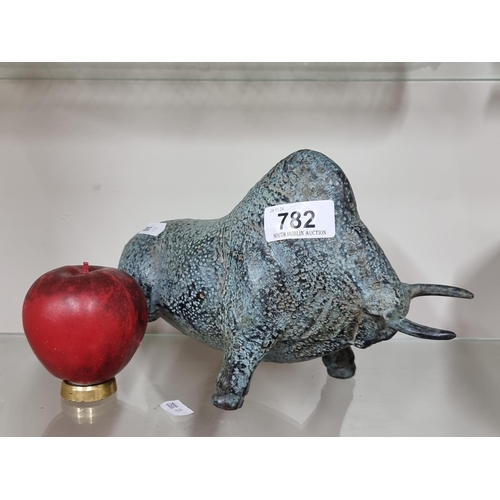 782 - Star Lot: A heavy bronze sculpture of a bull figurine with a textured patina, capturing the robust s... 