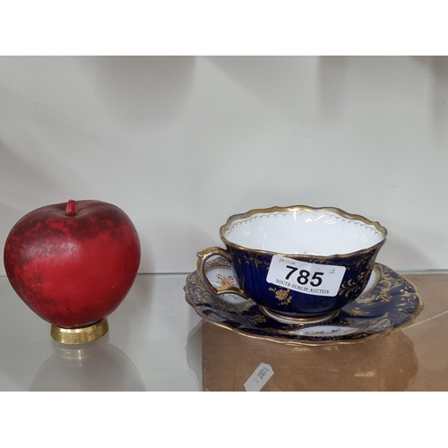 785 - A very pretty Meissen cup and saucer featuring hand painted detailing with gilt decoration atop a co... 