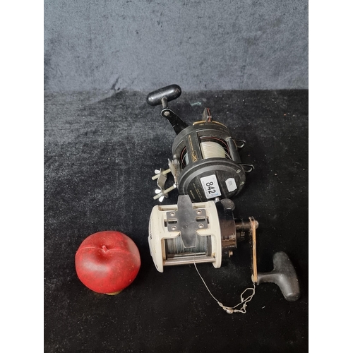 842 - A pair of fishing reels including a Mitchell Orca 55BT reel and a Shimano TLD20 reel.