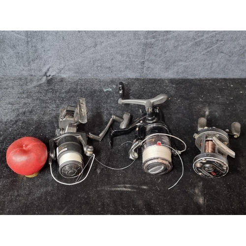 845 - Three fishing reels including a Millionaire Daiwa 6HM reel, an Impact Okuma IM50 reel along with a S... 