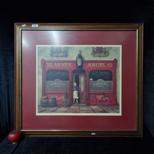 841 - A large vintage print of the Blarney Angel pub featuring a vibrant street scene. House in a wooden a... 