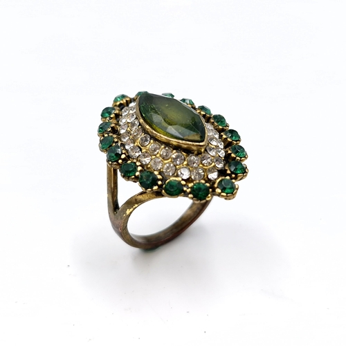 1208 - A multi stone marquee statement cocktail ring. Size - S. Weight - 8 grams.
Previous in auction on 14... 