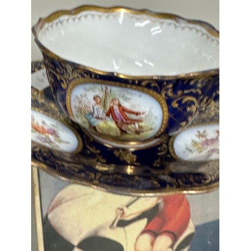 785 - A very pretty Meissen cup and saucer featuring hand painted detailing with gilt decoration atop a co... 