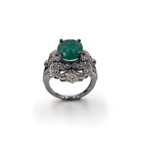 583 - Star Lot : An emerald stone ring set with diamond mount and set in sterling silver. Size - O. Weight... 